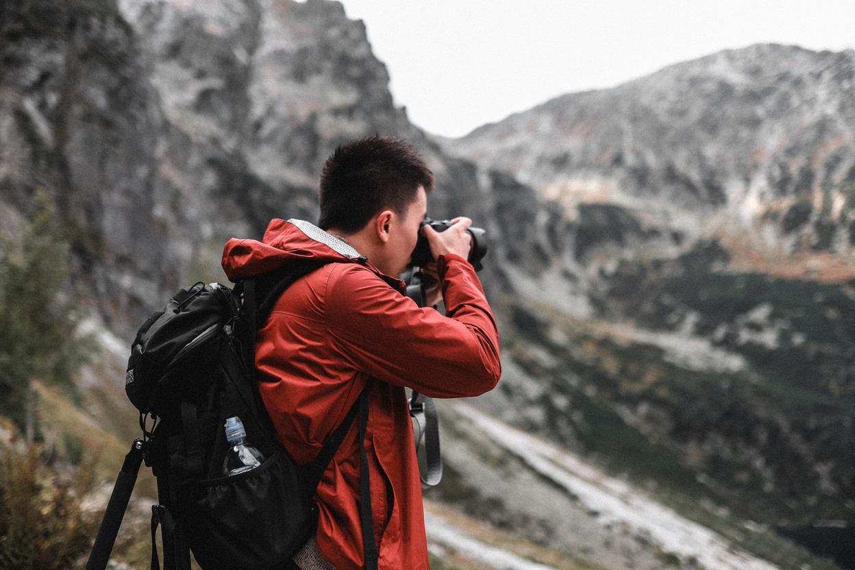 Photographer Taking Pictures In Mountains